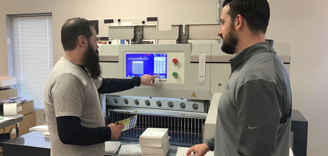 Bindery lead Mark Mullen and Jon Mullins with new PRISM paper cutter