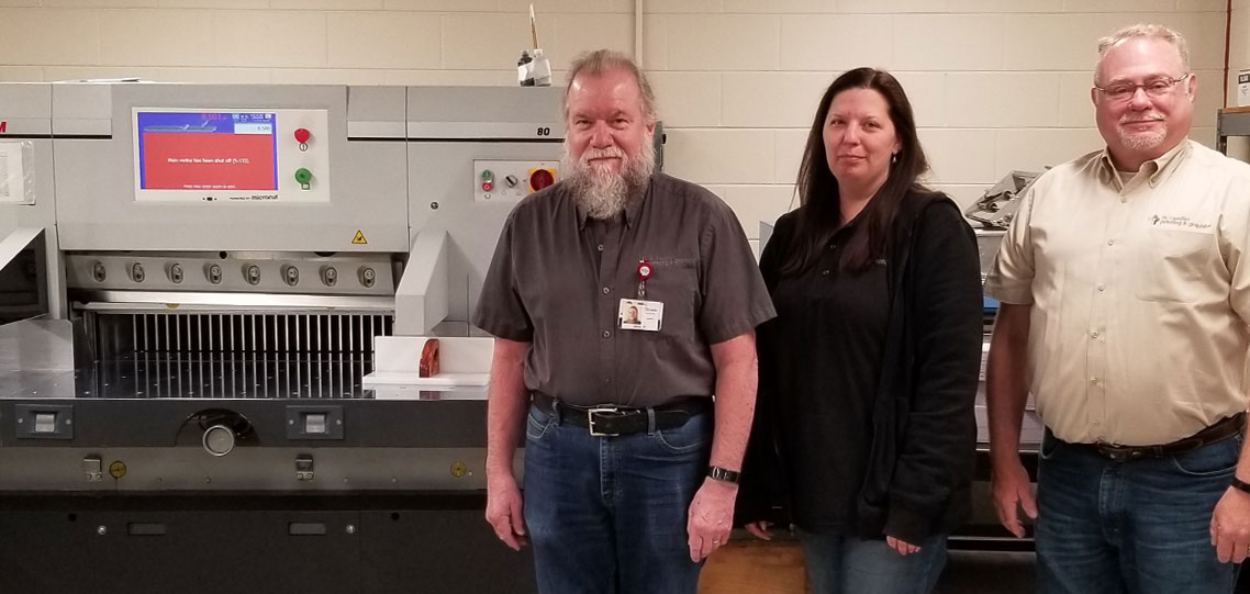 St. Camillus team pose with the new PRISM 80 paper cutter