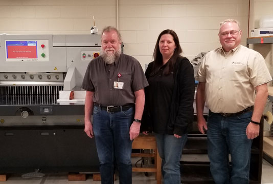 St. Camillus team pose with the new PRISM 80 paper cutter