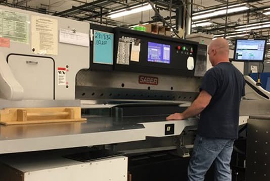 SABER paper cutter with infeed table and flip gate that front loads