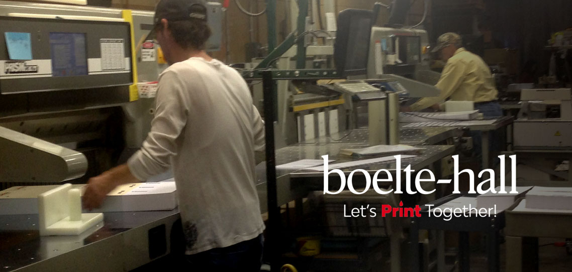 Two bindery veterans at work on PRISM paper cutters at Boelte-Hall.