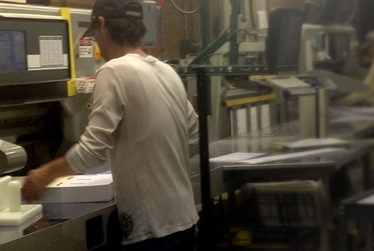 Two bindery veterans at work on PRISM paper cutters at Boelte-Hall.